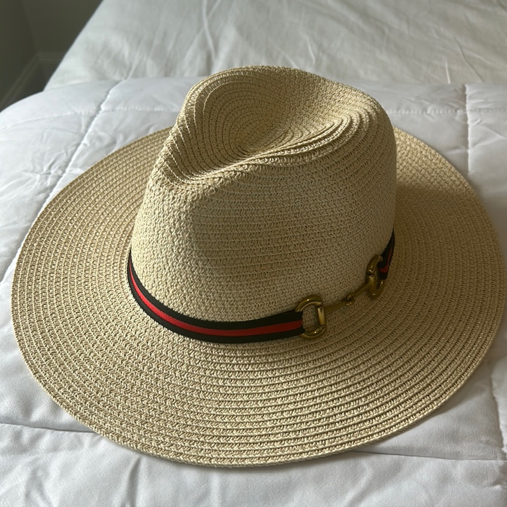 Straw hat with red and navy band and gold saddle straps